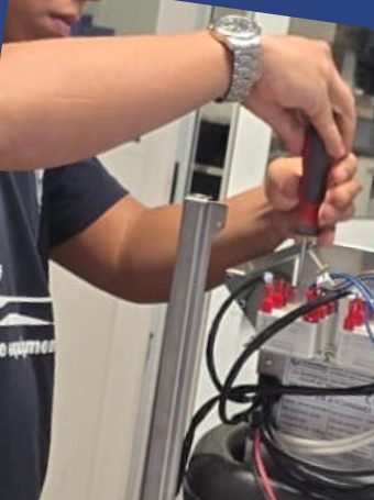 Technician fitting wiring with a screwdriver